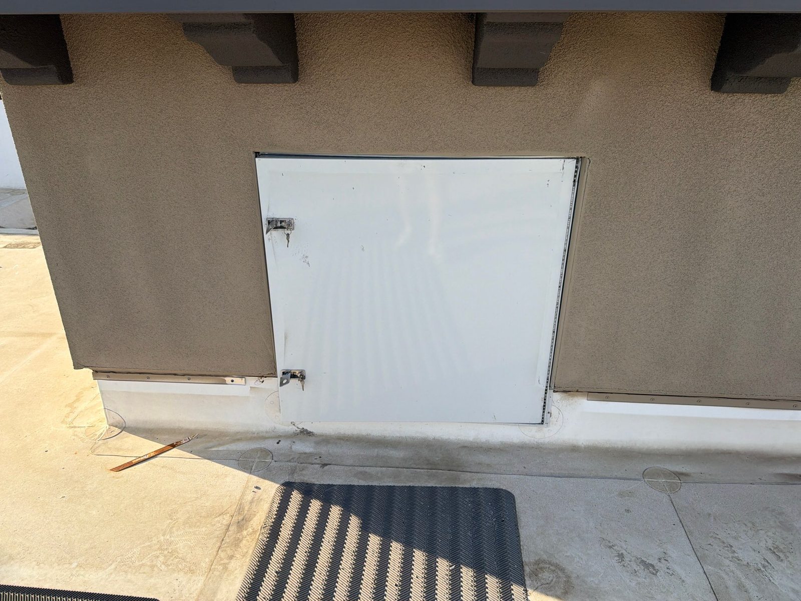 Roof access door and walk pads on a repaired roof
