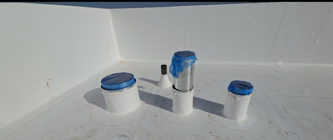 Pipe penetration boots at a parapet corner