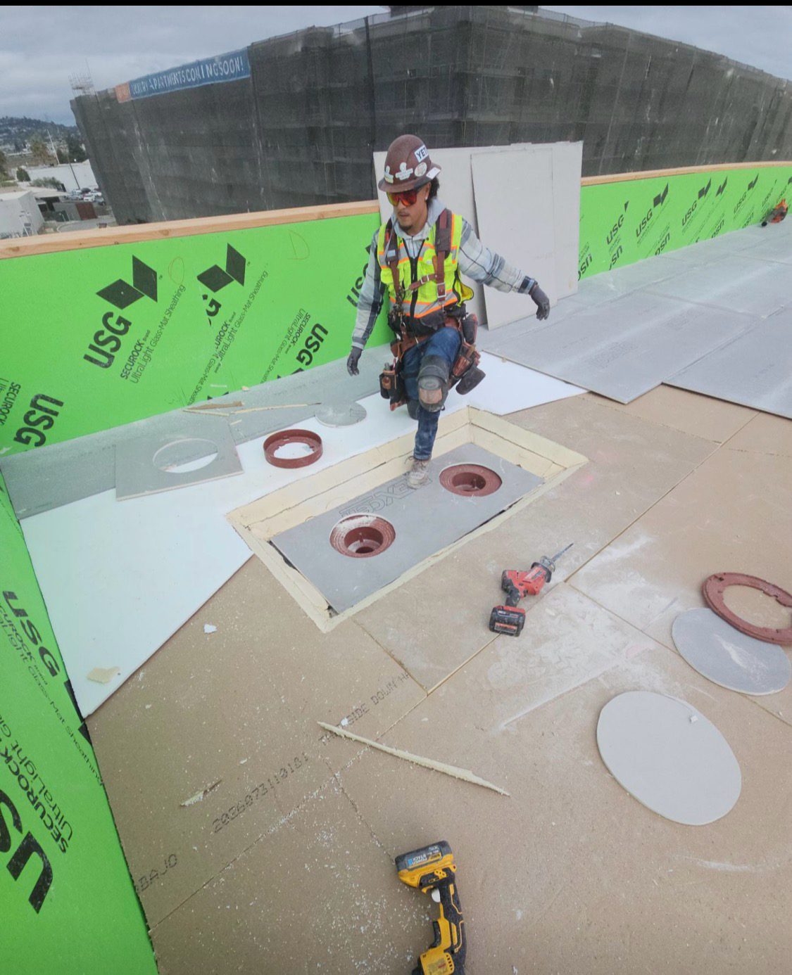 Crew installing curb flashing on a new deck