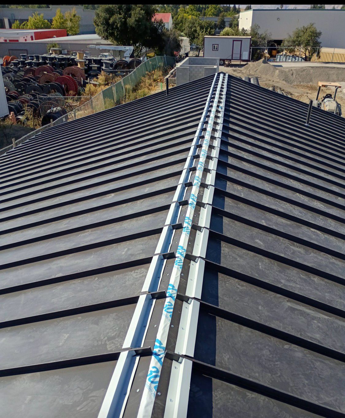 Standing seam metal roof with snow guard rail