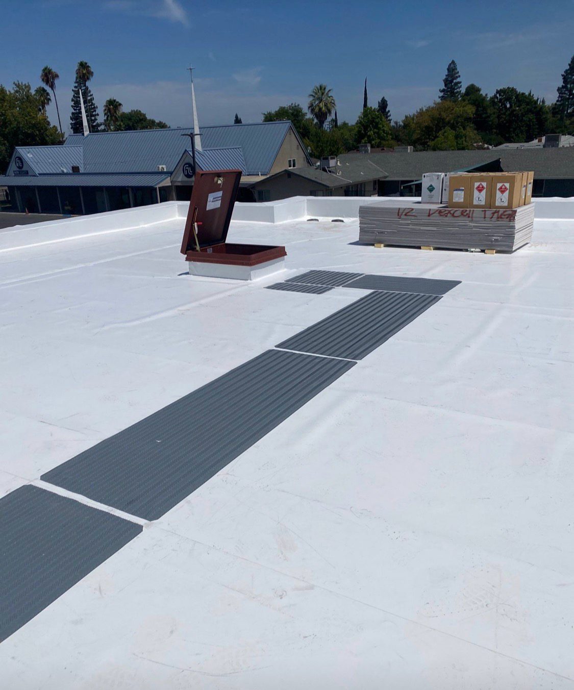Walkway pads and roof hatch on a completed membrane roof